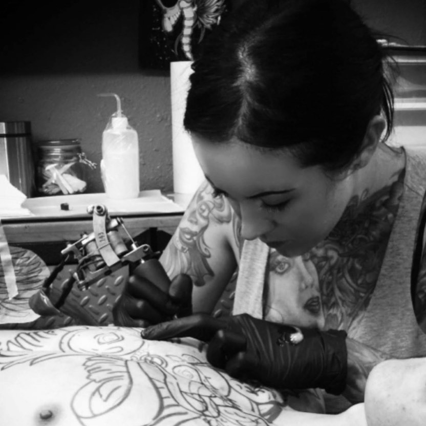 Sarah McGraw tattooing in the studio